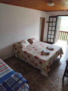 En eller flere senge i et værelse på Pousada e Restaurante Além das Nuvens