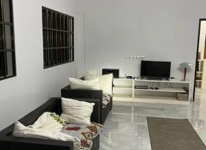 a living room with two couches and a television at Villa Stella in Lomé