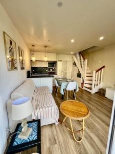 a living room with a couch and a table at L'esprit vacances-T3 à Port La Forêt in La Forêt-Fouesnant
