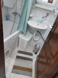 a bathroom with a sink and a tub and a toilet at Mala Sirena in Pirot +6 photos