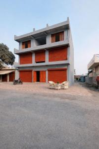 a building with two benches in front of it at Amrit Niwas in Prayagraj