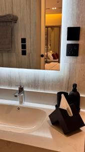 a bathroom with a sink and a mirror at Hanay Studio in Al Khobar