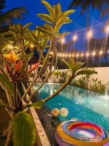 een zwembad met een zwembuis naast een resort bij Villa 2A in Matara