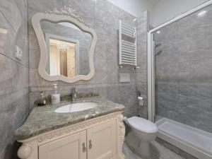 a bathroom with a sink and a toilet and a mirror at innstation guesthouse in Rome