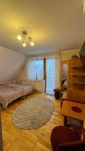 a bedroom with a bed and a large rug at Pokoje Ewka in Czarna Góra