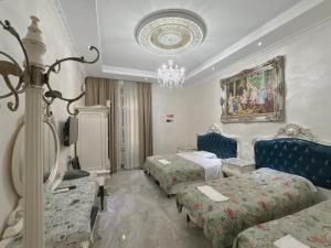 a hotel room with two beds and a chandelier at innstation guesthouse in Rome