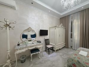 a bedroom with a dressing table and a mirror at innstation guesthouse in Rome