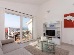 a living room with a couch and a glass table at Apartmani Attila in Trogir