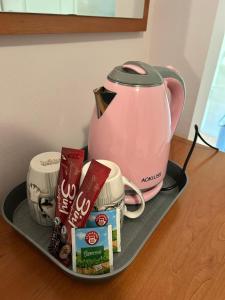 a tray with a tea kettle and other items on it at Vila Dunjić Prolom Banja in Prolomska Banja