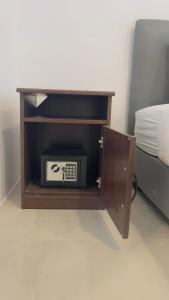 a small radio in a cabinet next to a bed at Beautiful Bungalow 5, Koh Chang in Ban Dan Mai