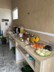a table with a bunch of food on it at Loft 11, caminho do mirante in Iguaba Grande