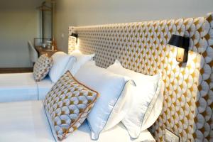 a bedroom with two beds with white pillows at Hortus Hotel Tirana in Tirana +142 photos