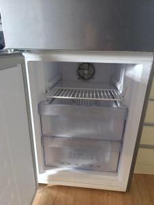 an empty refrigerator with its door open in a kitchen at Sarajevo Hills-POOL&JACUZZI private garden Home-Near Old Town in Sarajevo