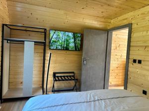 a bedroom with a bed and a window and a chair at Hotel McPietroasa in Haleş +51 photos