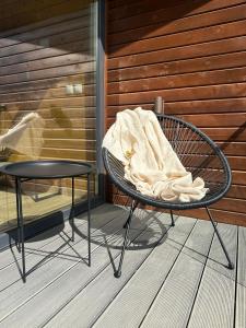 a blanket sitting on top of a chair on a porch at Hotel McPietroasa in Haleş