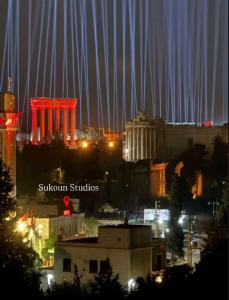 a view of a city at night with lights at Sukoun Studios in Baalbeck +9 photos