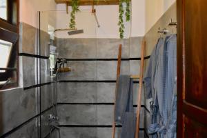 a bathroom with a shower and a glass wall at BREATHE Collections Habaraduwa in Habaraduwa +46 photos