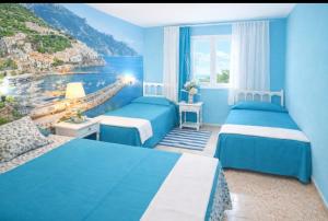 a bedroom with two beds and a view of the ocean at Can Pau Santa Parascheva in Llança