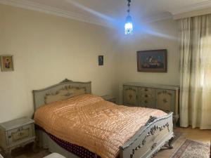 a bedroom with a bed and two dressers at Ramo Square hostel in 6th Of October