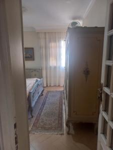 a bedroom with a bed and a dresser in a room at Ramo Square hostel in 6th Of October