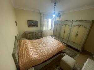 a bedroom with a bed in the corner of a room at Ramo Square hostel in 6th Of October
