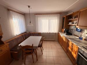 a kitchen with a table and a table and chairs at Naturblick am Dorfausgang in Rheinau +2 photos