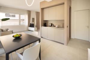 a kitchen and living room with a table and chairs at Santa Lucia Suites in Padova