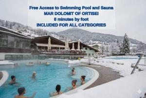 a rendering of a pool at a ski resort in the snow at AppartChalet LA RONDULA - 100m from Seceda in Ortisei