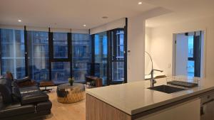 a kitchen with a counter and a living room at FV 1BR APT with Rooftop Pool in Brisbane