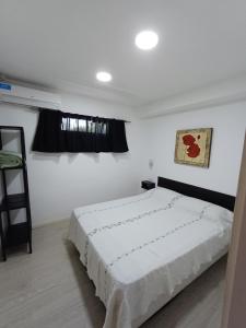 a bedroom with a white bed and a window at La Villa Inn in Villa Carlos Paz +103 photos