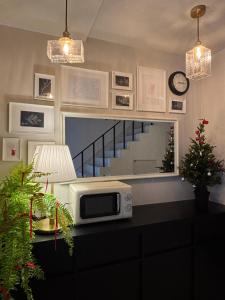 a kitchen with a microwave on a counter with a mirror at 무무 mumu in Seoul