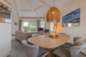 a dining room with a table and chairs at Beach & Bunker in Hollum
