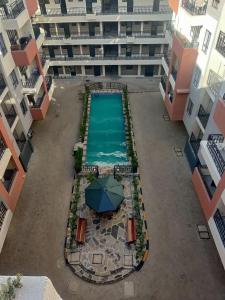 an overhead view of a swimming pool with an umbrella at Solara Loft in Nairobi