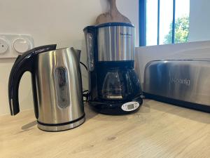 a blender sitting on a counter next to a toaster at Bruisse in Les Iffs