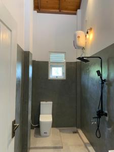 a bathroom with a toilet and a camera at Villa Carla Mirissa in Mirissa