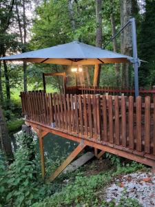 a gazebo with an umbrella on a bridge at La Garette in Elbeuf-sur-Andelle