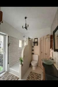a bathroom with a sink and a toilet and a window at Le Domaine de Cécile by Alto Service in Perpignan +21 photos