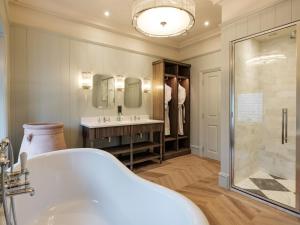 a bathroom with a tub and a shower and a sink at Douneside House in Tarland +45 photos