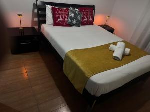 a bedroom with a bed with two towels on it at ARTEMIS HOUSe in Kakopetria