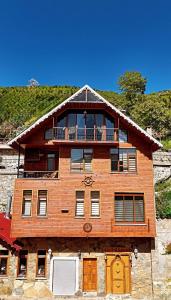 a wooden house with a balcony on top of it at İsgobya Dağ Evleri 101 in Macka +18 photos