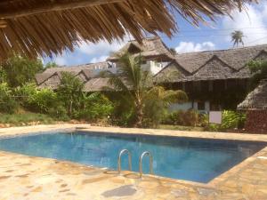 a swimming pool in front of a resort at Emerald Bay Resort in Kizungu