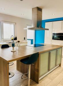 a kitchen with a wooden counter top in a room at l'imperial WIFI & Confort in Brussels +37 photos