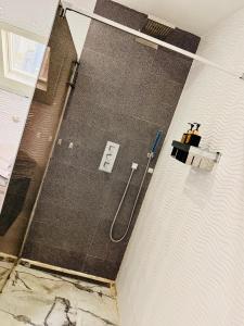 a bathroom with a shower stall with a shower at l'imperial WIFI & Confort in Brussels