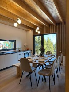 a dining room with a long table and chairs at Cabana Nord Side in Muntele Cacovei