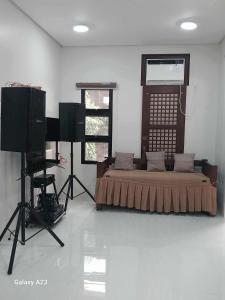 a room with a bed and a television and a camera at Sehaliah Agricultural Farm Resort in Amadeo