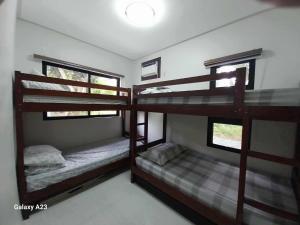 two bunk beds in a room with two windows at Sehaliah Agricultural Farm Resort in Amadeo +6 photos
