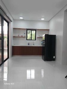 a large kitchen with a sink and a counter at Sehaliah Agricultural Farm Resort in Amadeo