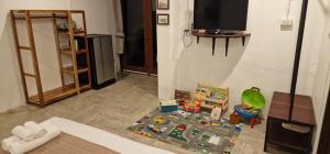 a living room with a toy train on a rug at Kingfisher House in Sangkhla Buri
