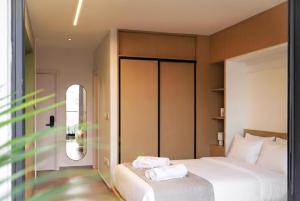 a bedroom with a bed with white towels on it at Aweso Limassol in Limassol