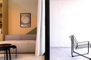 a living room with a couch and a chair at Aweso Limassol in Limassol